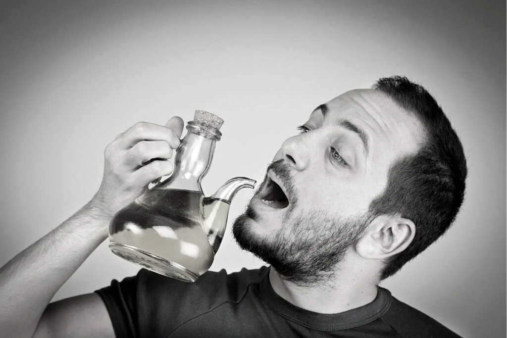 guy trying to drink coconut oil