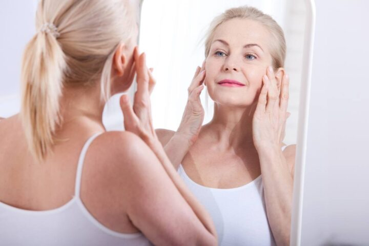 collagen benefits for skin, older woman in mirror